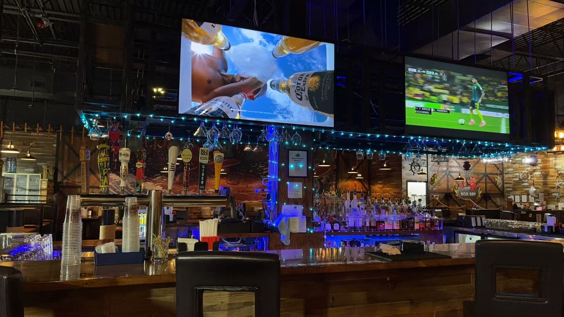 Boil Bay bar with big screens and blue lights